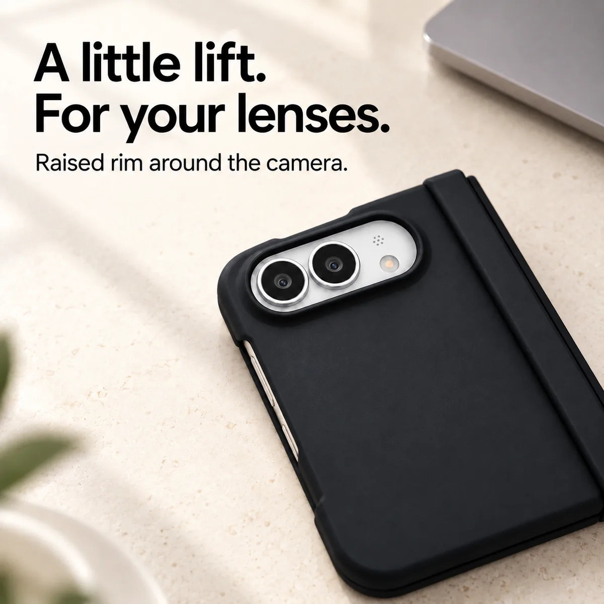 Close-up of the raised Black camera rim on a matte iPhone Ultra case resting on a light desk. #color_Onyx Black