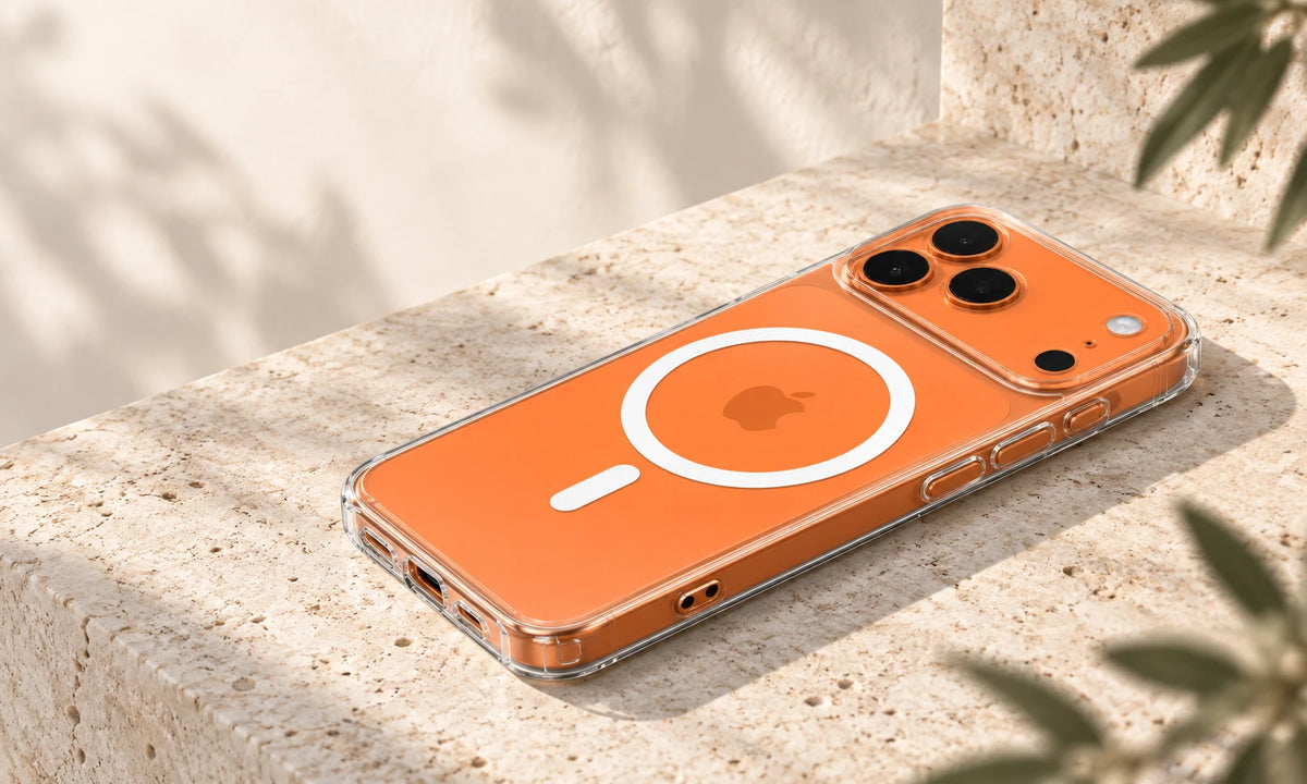 Clear phone case on an orange phone viewed from the side on a stone desk.