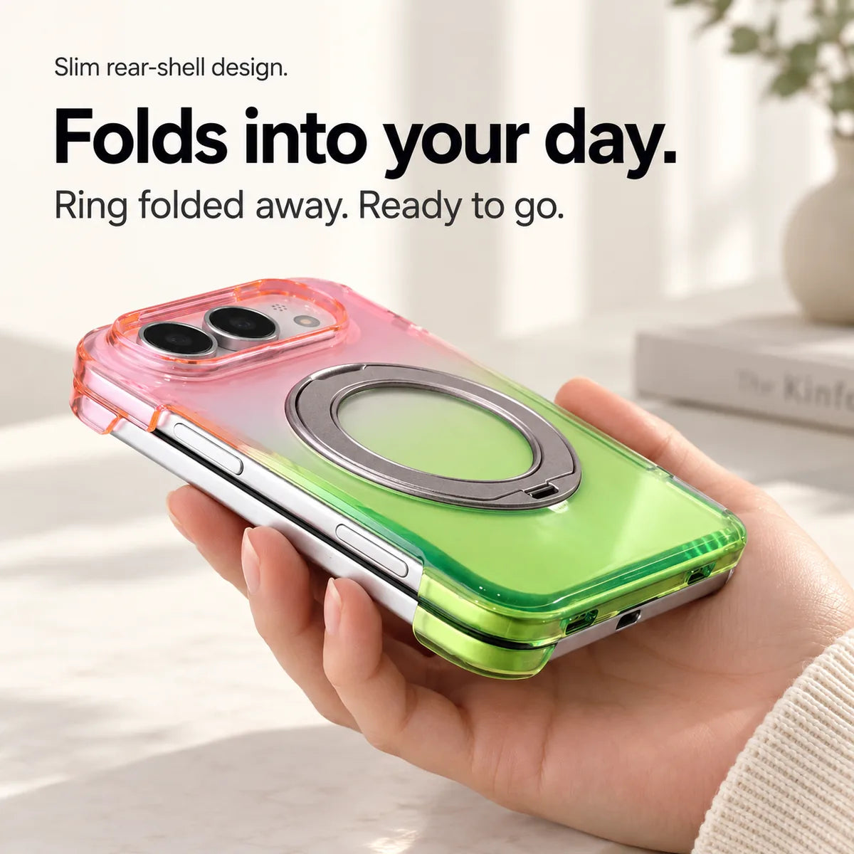 Pink and green gradient rear case shown from the side on a folded silver phone with the ring stored flat. #color_Aurora Bloom