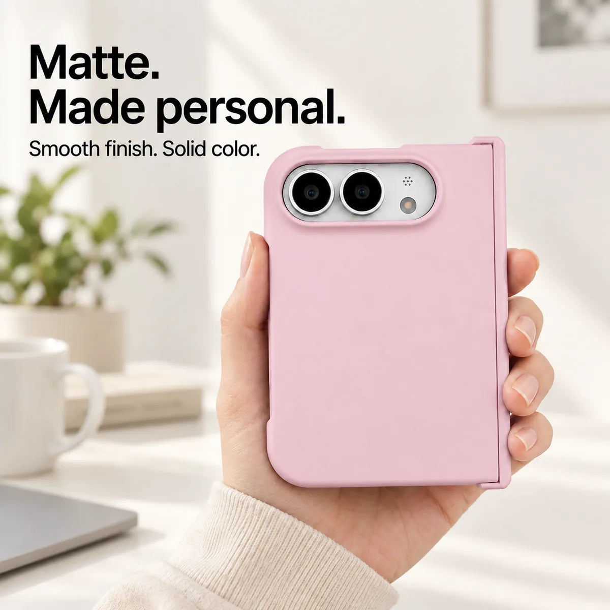 Pink matte iPhone Ultra case held in one hand, with a smooth solid-color rear shell and silver camera area. #color_Petal Pink